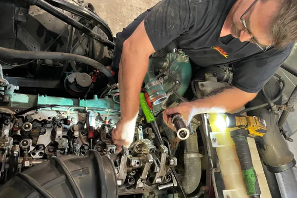 Mobile diesel mechanic repairing a truck engine on-site Mobile diesel mechanic repairing a truck engine on-site