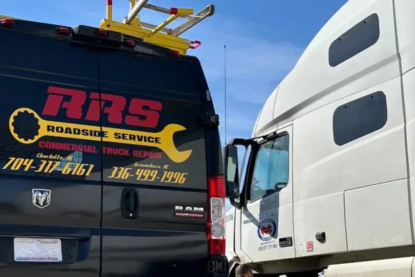 Red Rover Service roadside repair van parked beside a semi truck Red Rover Service roadside repair van parked beside a semi truck