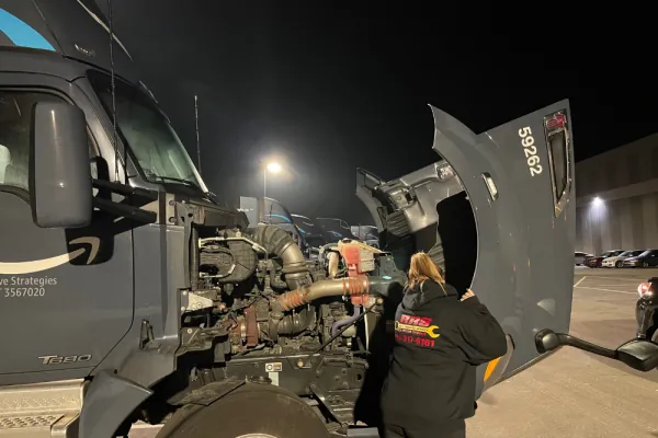Red Rover Service technician repairing a semi truck engine on-site Red Rover Service technician repairing a semi truck engine on-site